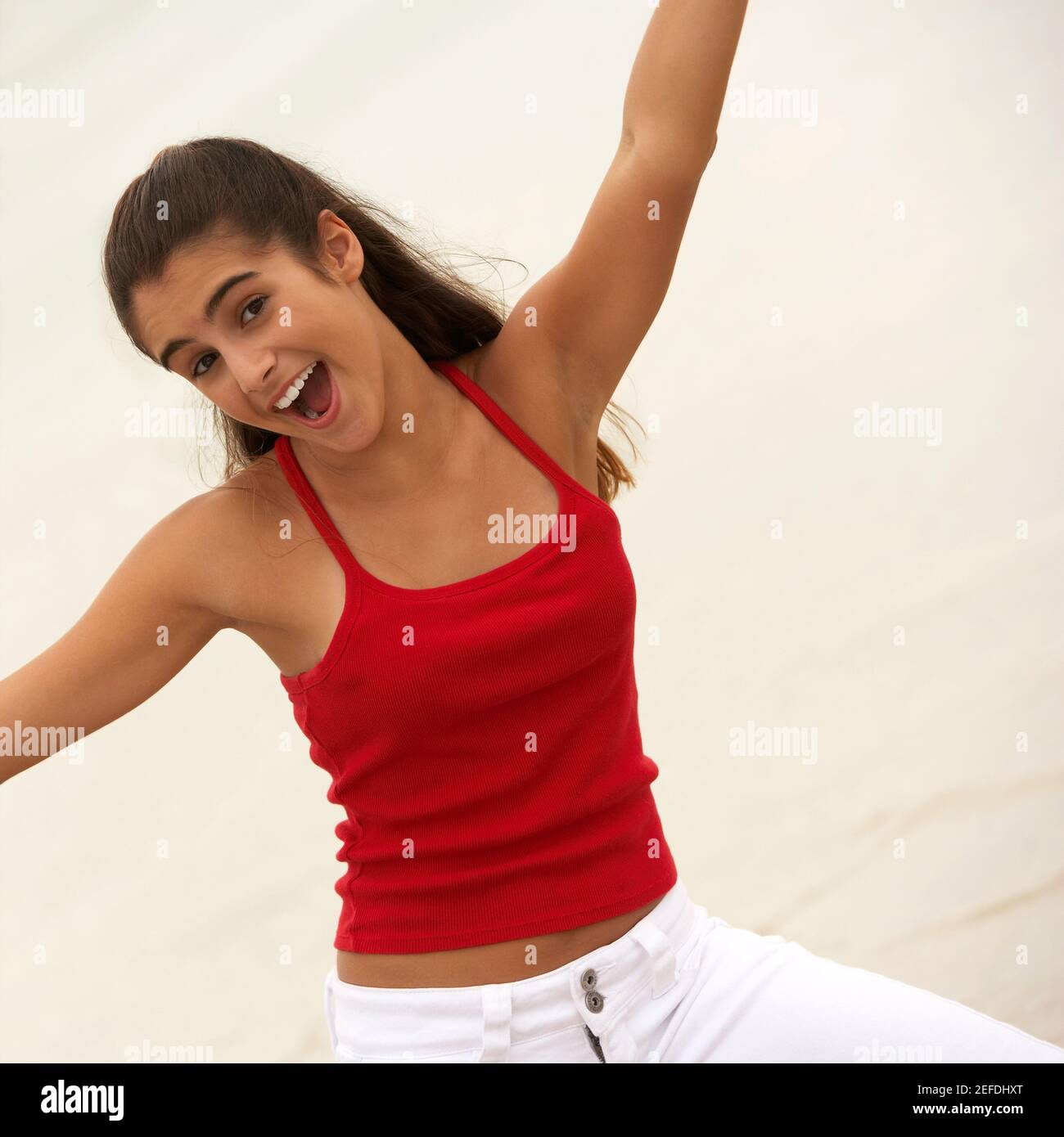Portrait of a girl smiling with her arms raised Stock Photo - Alamy