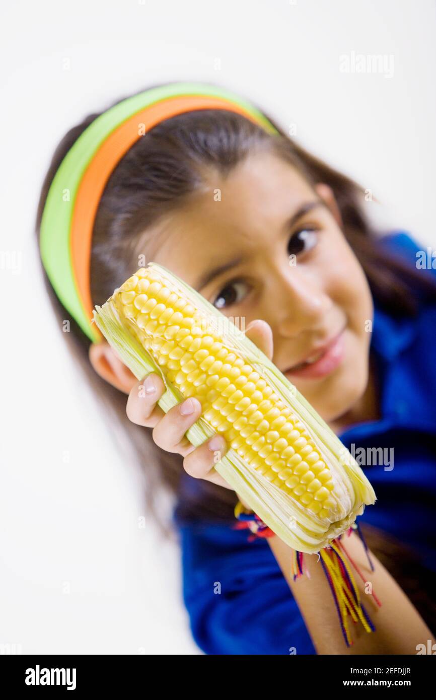 Portrait of a girl holding a corn cob Stock Photo - Alamy