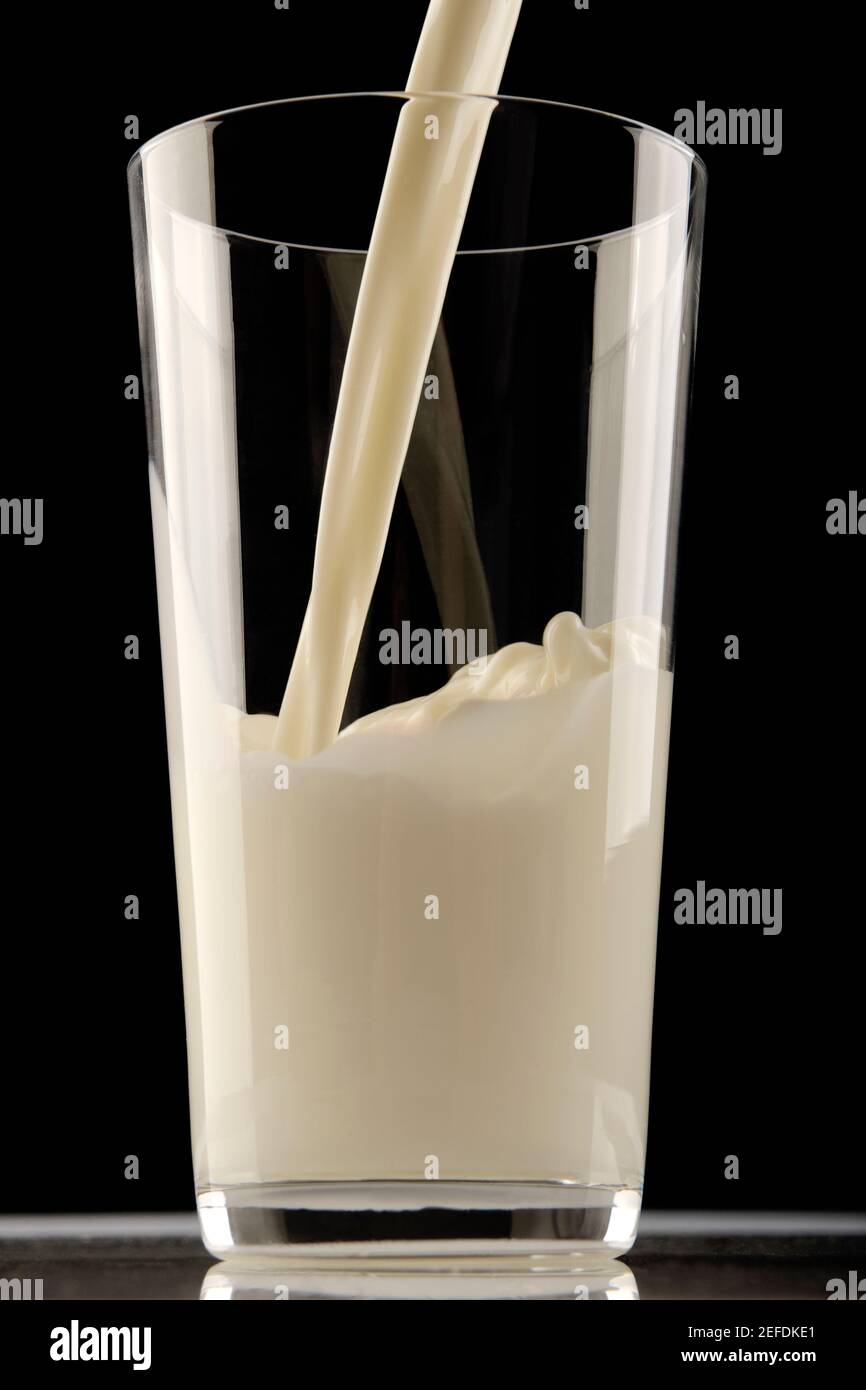 Milk being poured in a glass Stock Photo Alamy