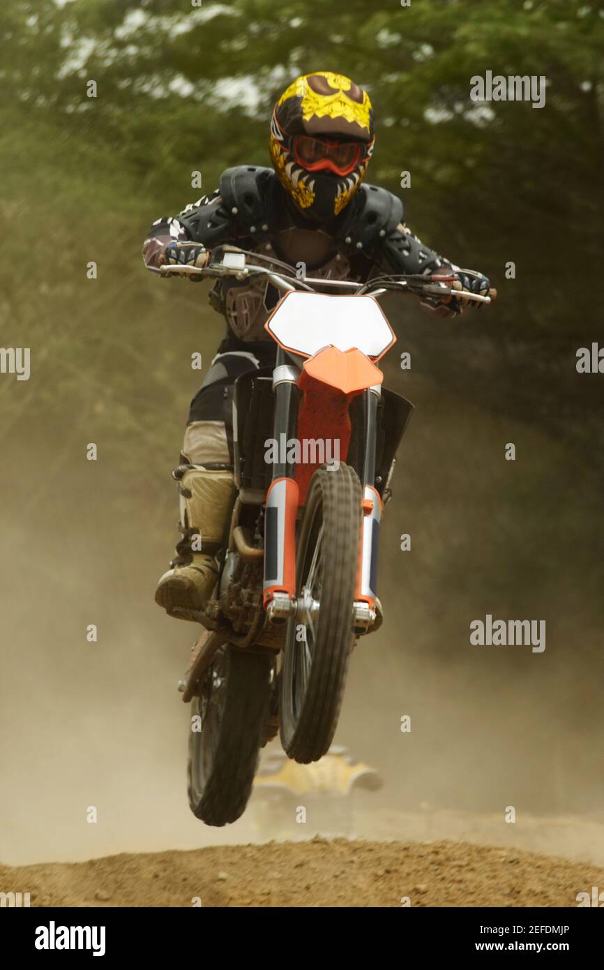 Motocross rider performing a jump on a motorcycle Stock Photo Alamy