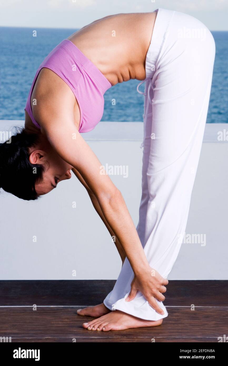 Side profile of a young woman exercising Stock Photo