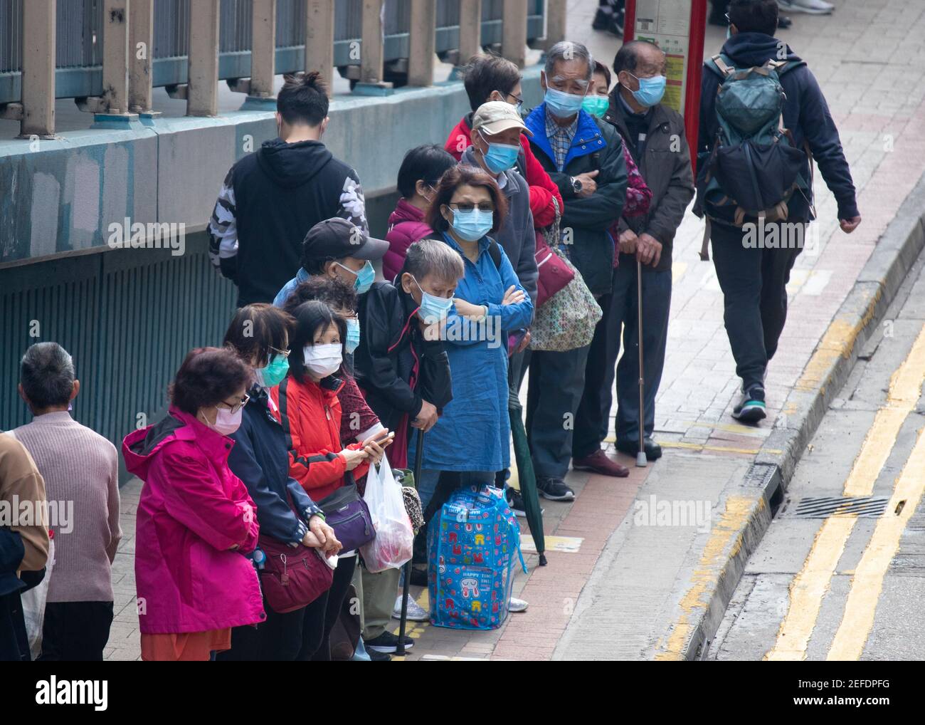 2021 Jan 22,Hong Kong.During the epidemic, citizens wearing masks are waiting for the bus Stock Photo