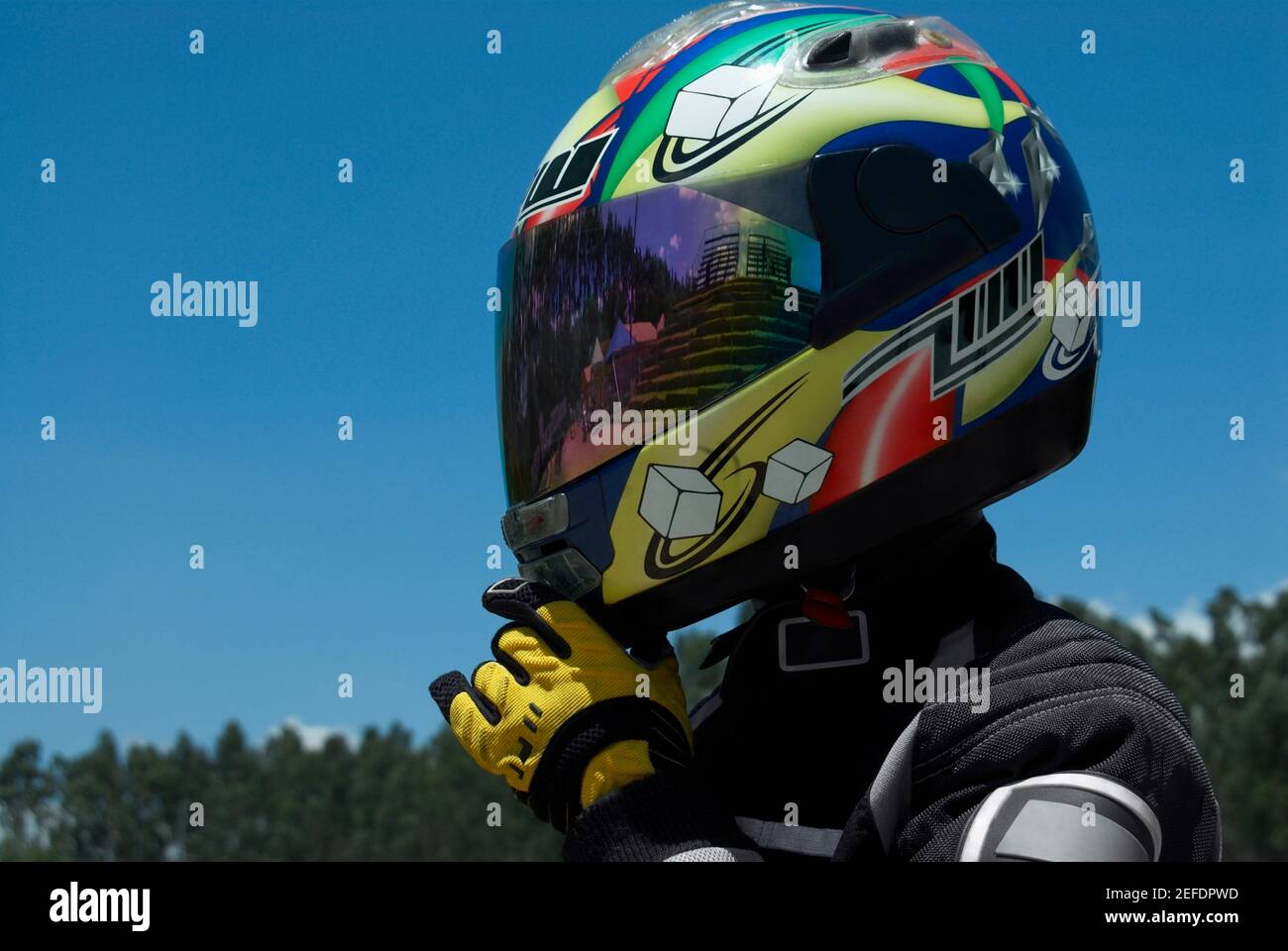 Close-up of a person adjusting his crash helmet Stock Photo - Alamy