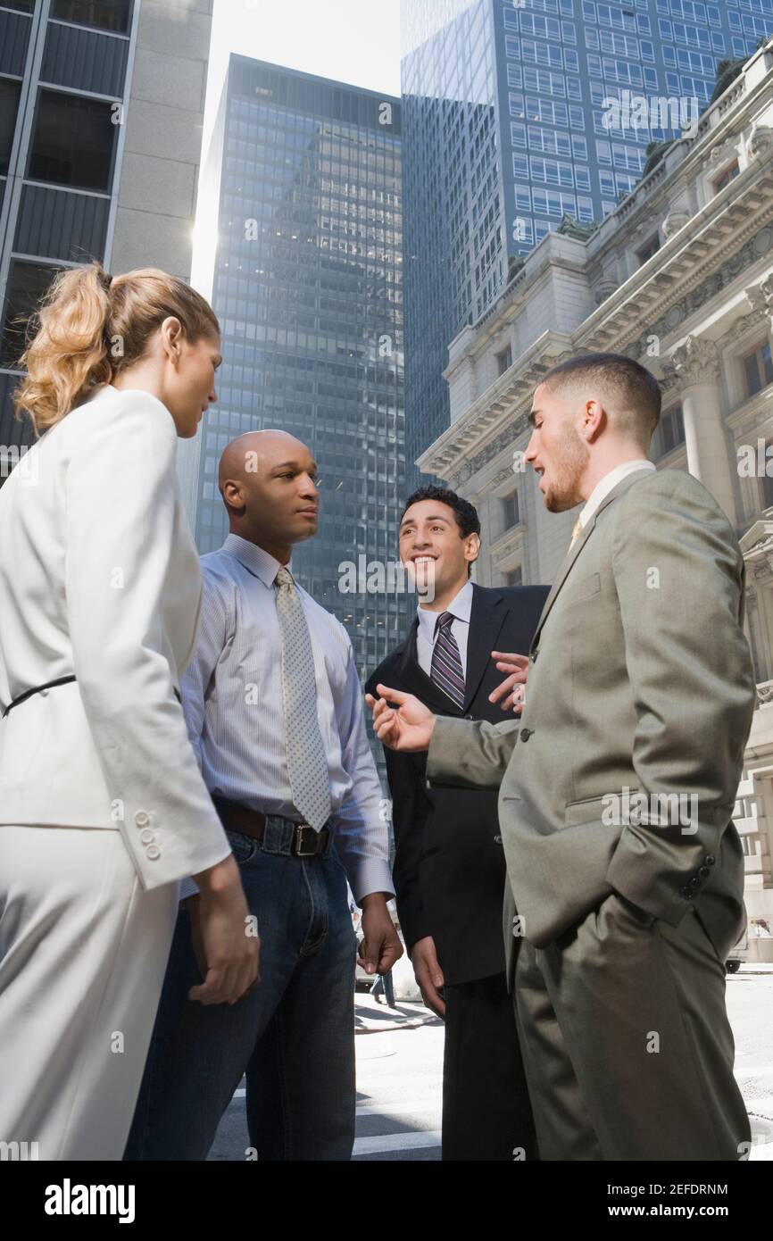 Side profile of a businesswoman standing with three businessmen Stock ...