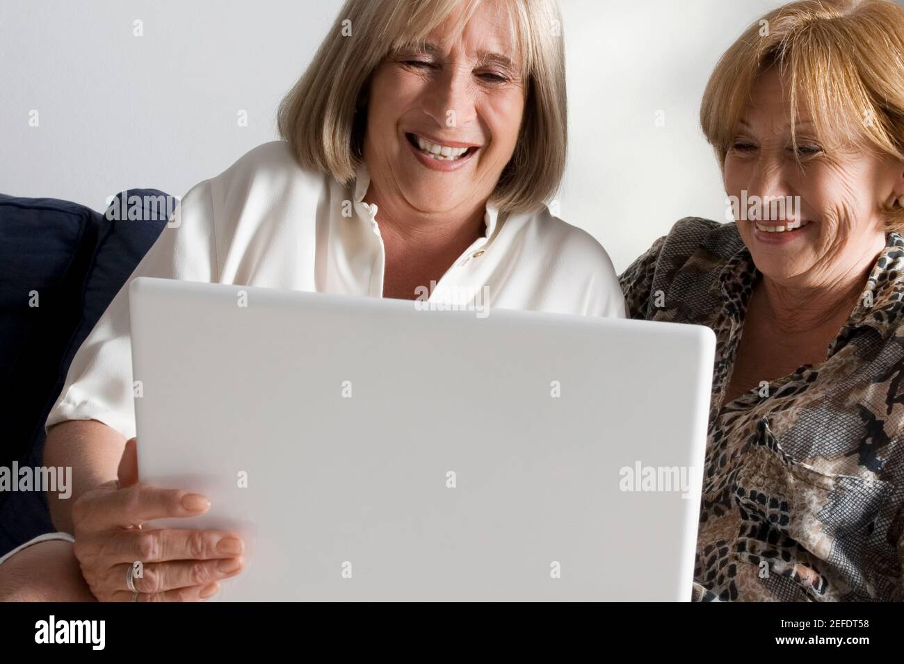 Two senior women looking at a laptop Stock Photo - Alamy