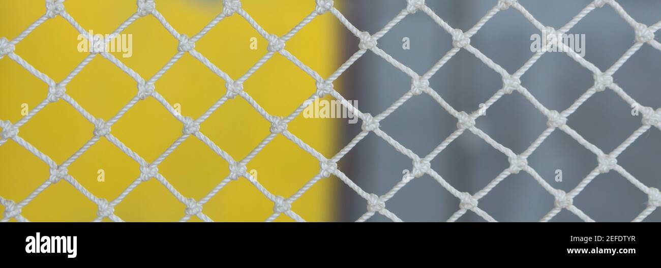 White net on yellow gray abstract background with selective focus. Banner Stock Photo