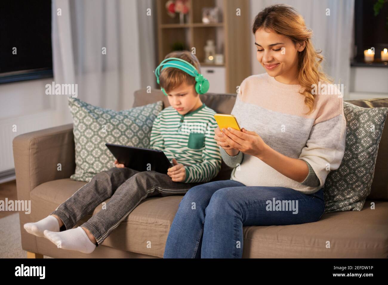 mother and son using gadgets at home Stock Photo - Alamy