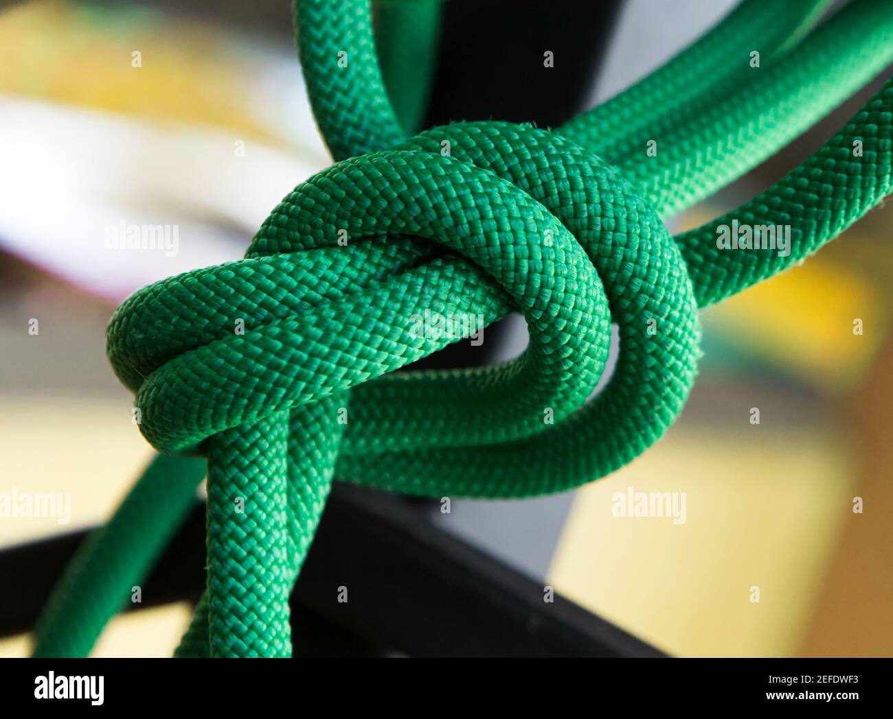 Close up green rope with knot on selective focus background Stock Photo