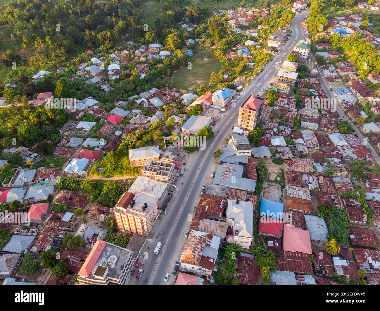 Aerial Drone shot of Chake Chake City, a Capital of Pemba island, Zanzibar archipelago. City in a river Delta at sunset time Stock Photo