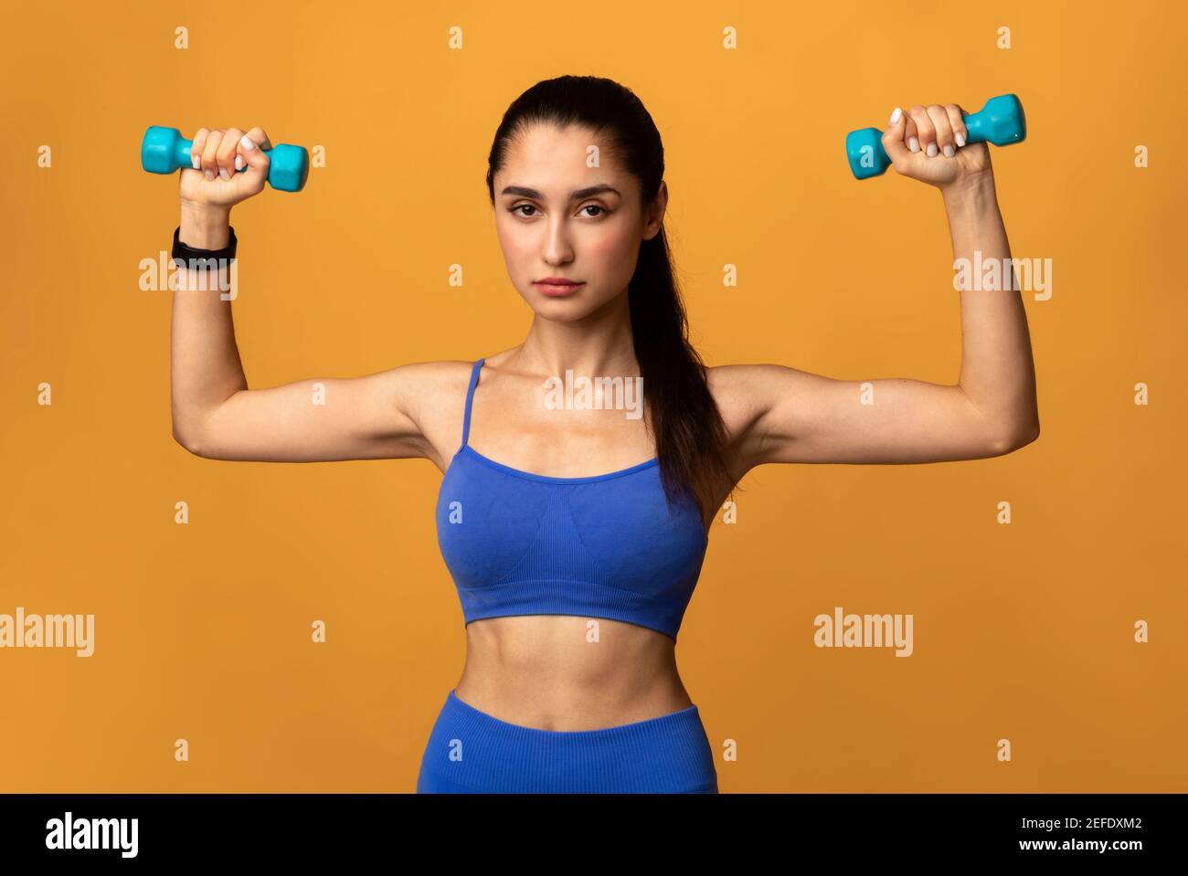 Fitness and sport. Focused middle aged woman workout with elastic band,  pump biceps and muscles, doing arms exercises in gym, white background  Stock Photo - Alamy