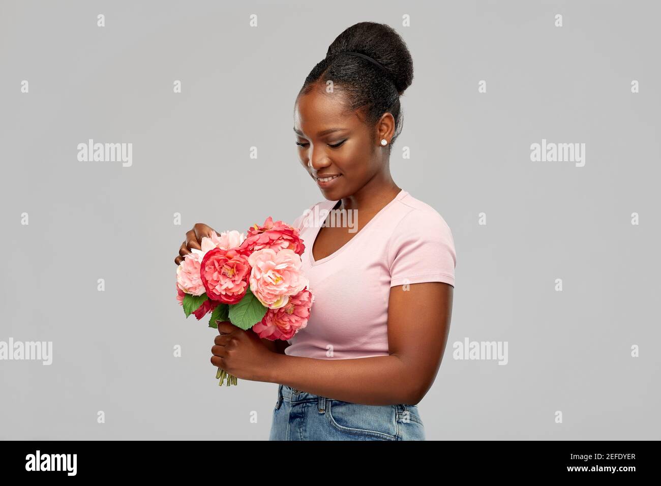 happy african american woman with bunch of flowers Stock Photo - Alamy