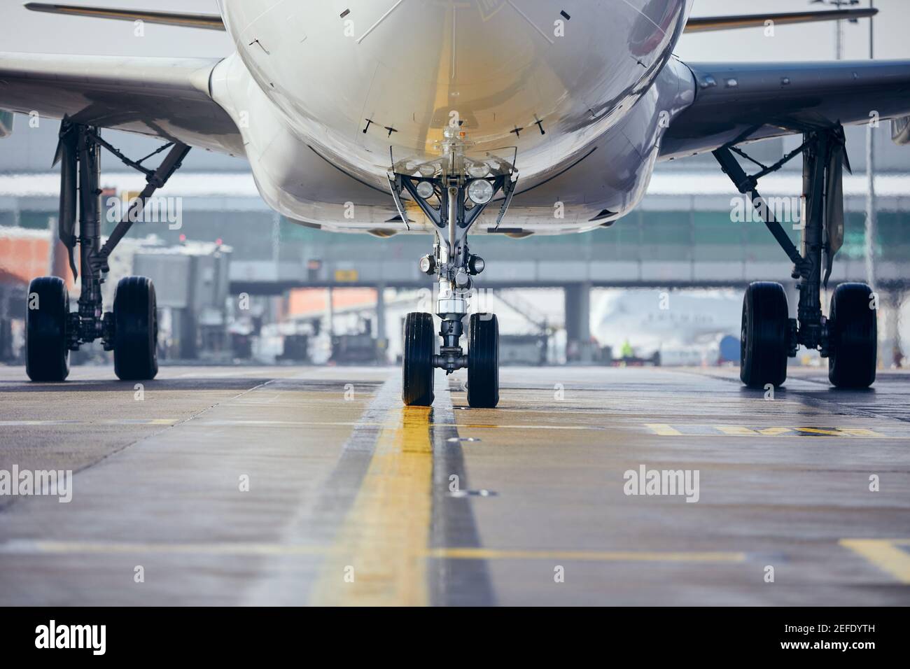 Front view of plane at airport. Commercial airplane taxiing to runway before take off. Stock Photo