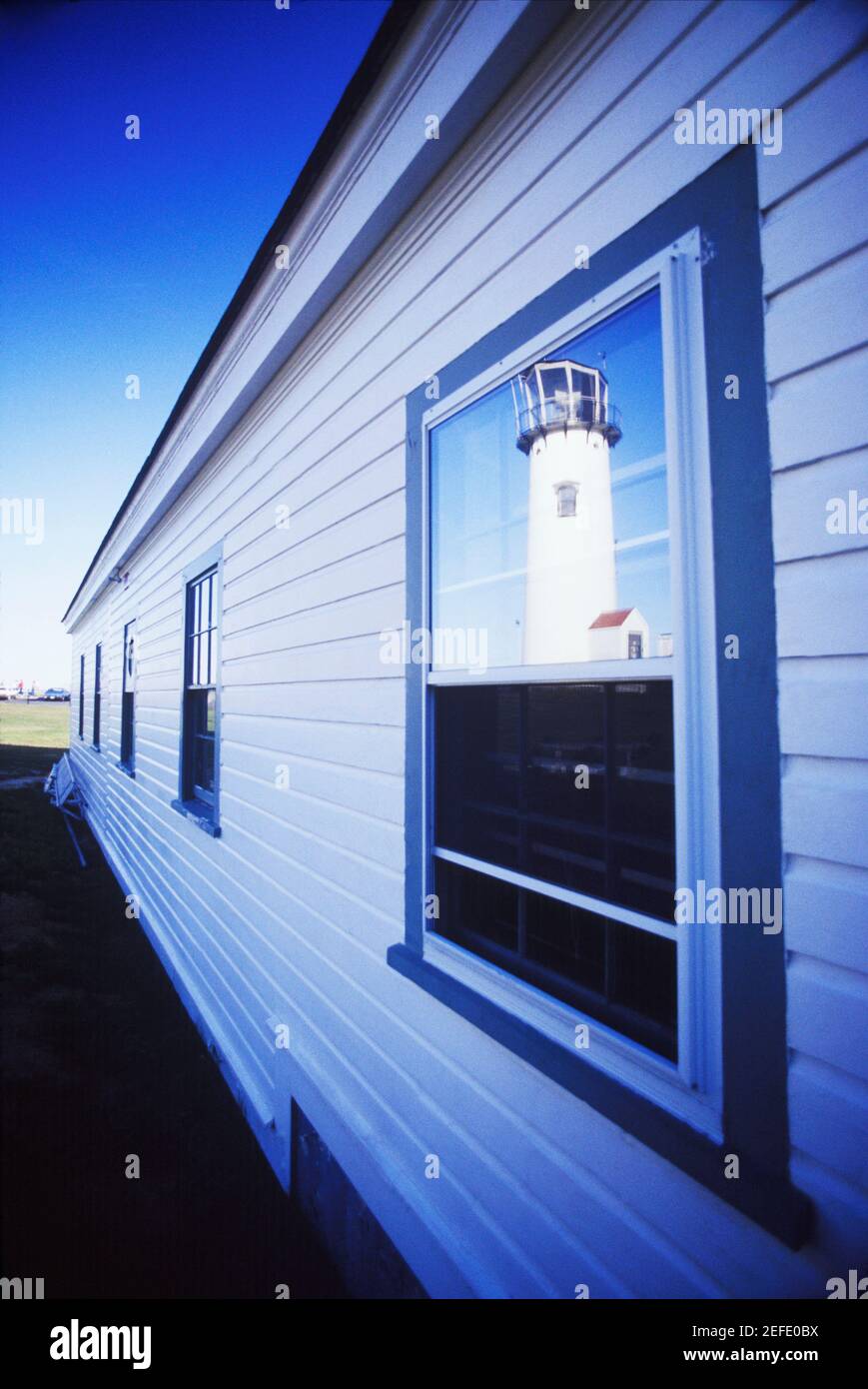 Lighthouse Window Types Reflection of a lighthouse in the window of a building, Cape Cod ...