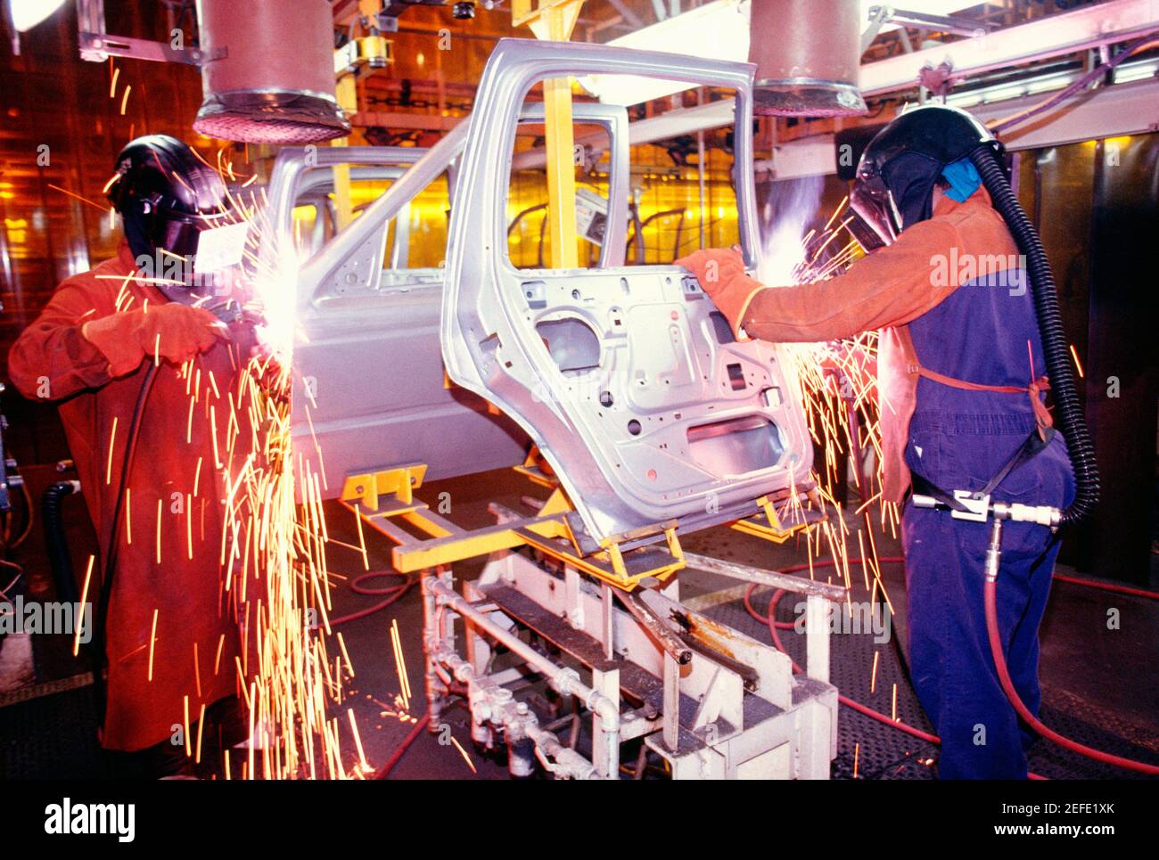 Welder working on car doors in an assembly line, Newark, Delaware, USA Stock Photo