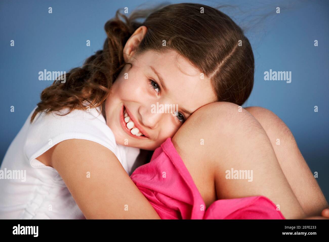 Portrait of a girl hugging her knees Stock Photo - Alamy