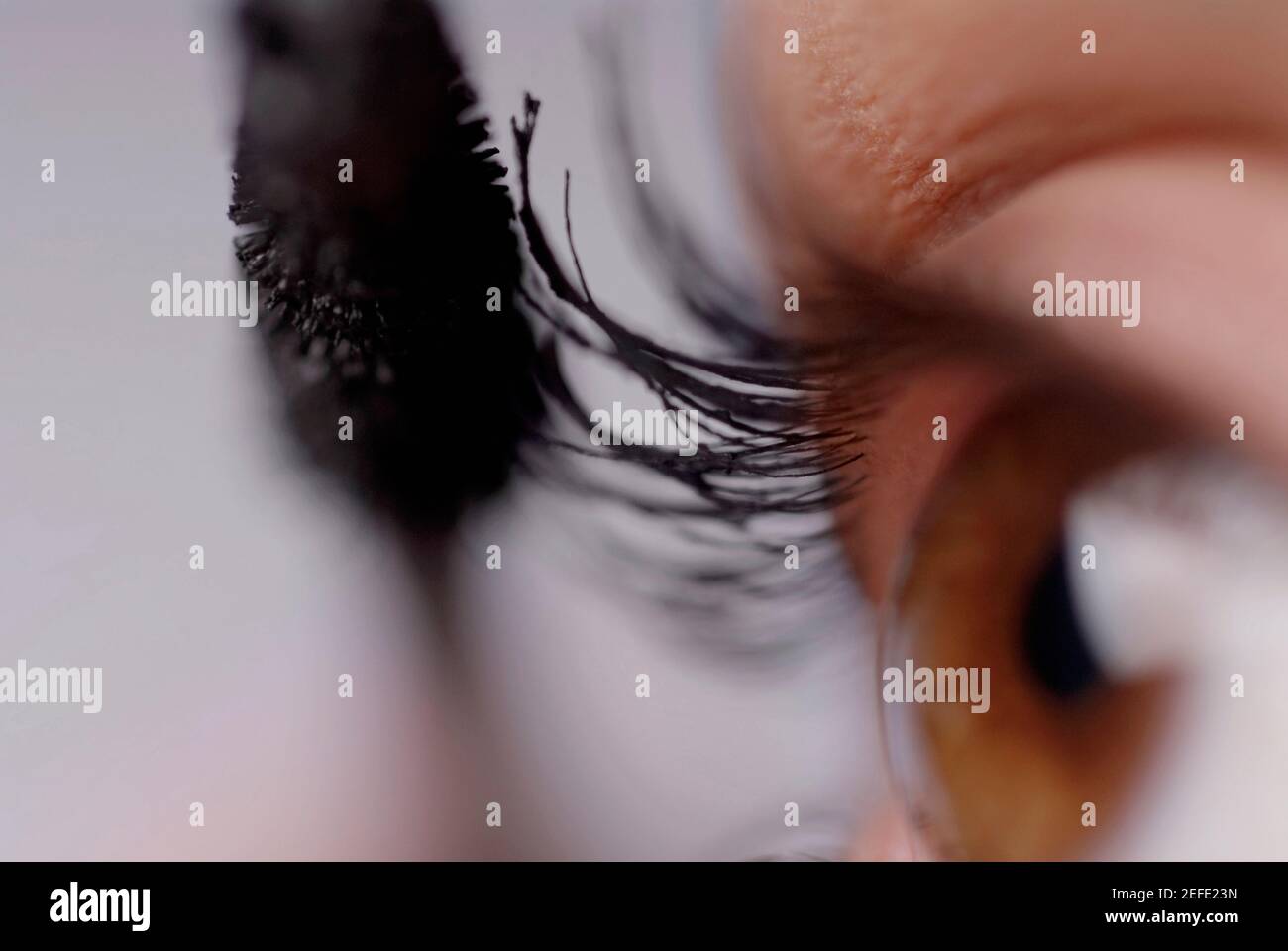 Close-up of a young woman applying mascara Stock Photo