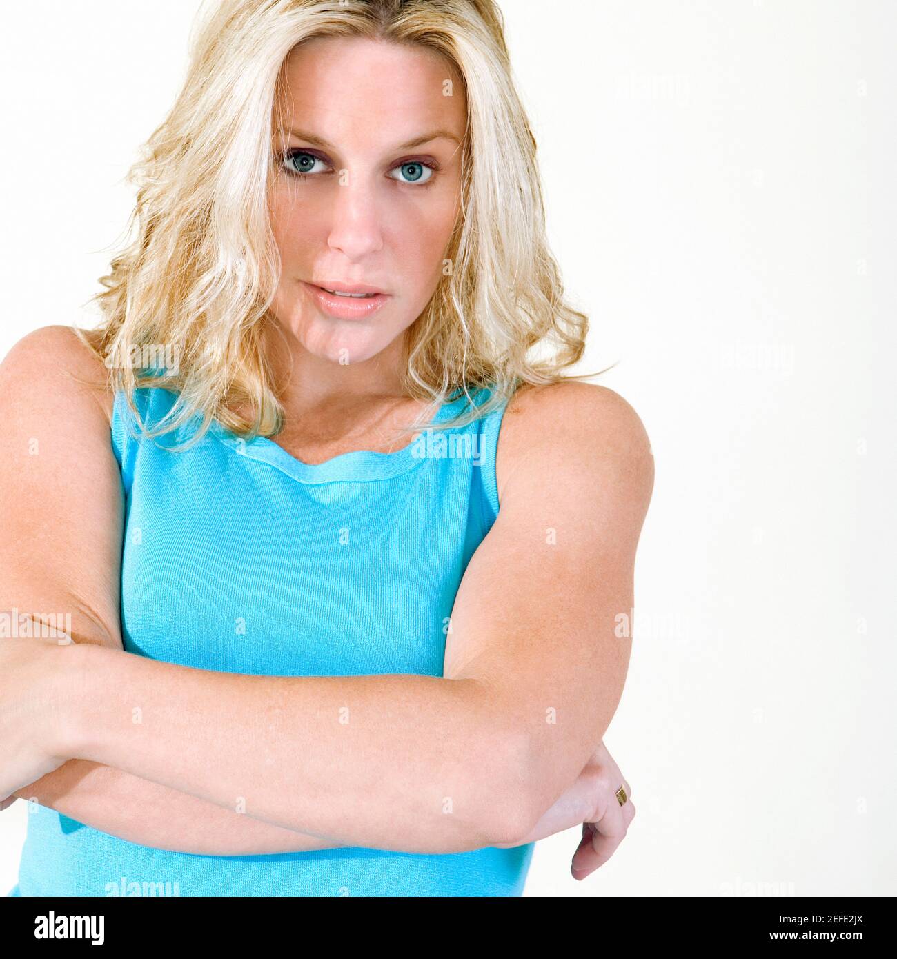 Portrait of a young woman with her arms crossed Stock Photo - Alamy