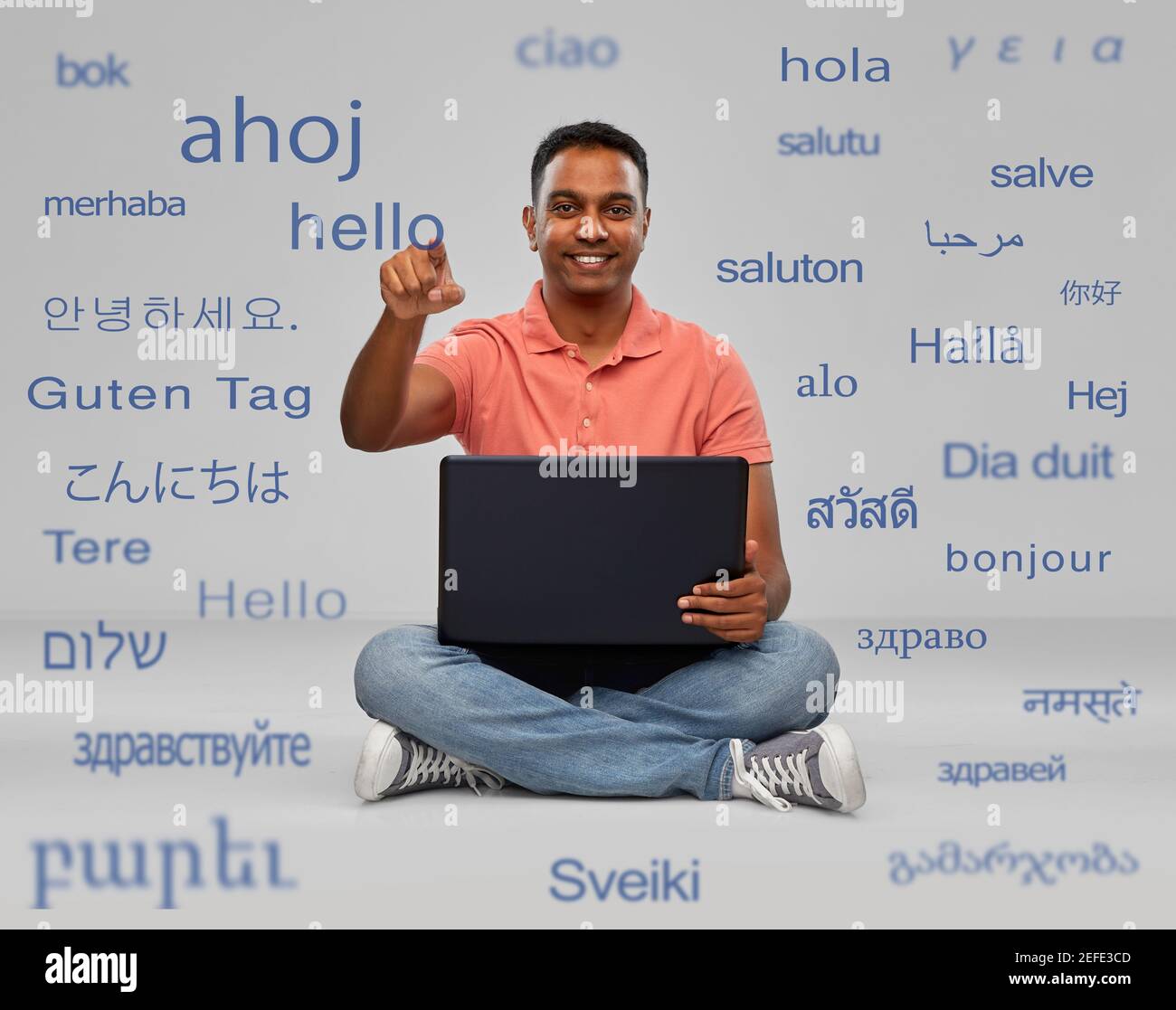 happy indian man with laptop learning languages Stock Photo