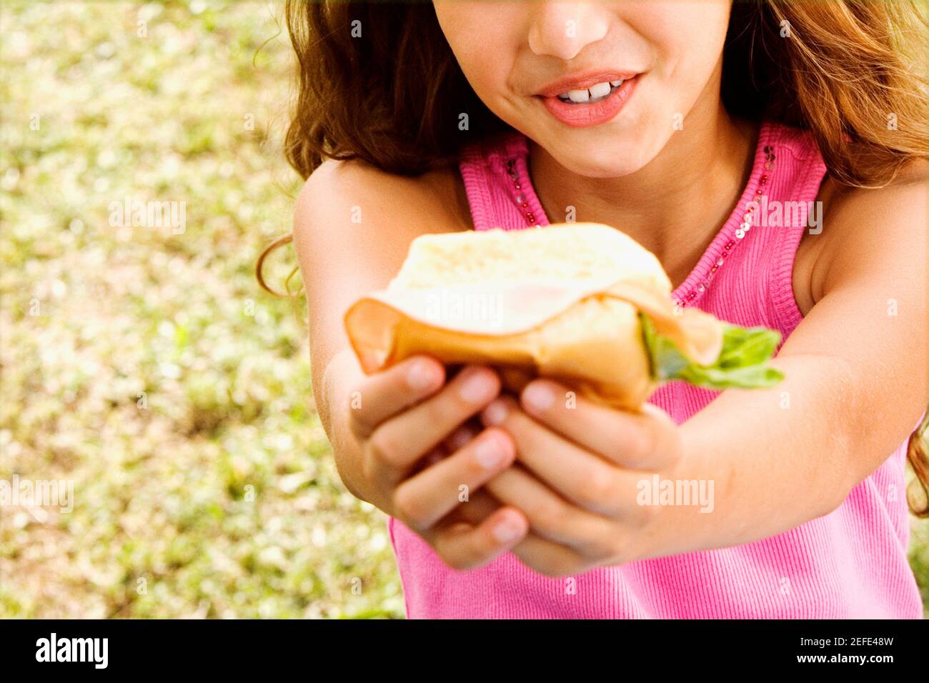 Close-up of a girl holding a hamburger Stock Photo