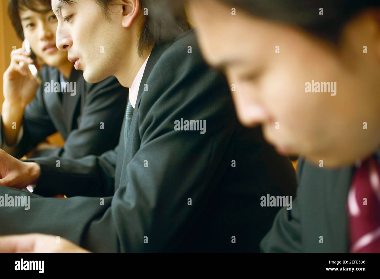 Side profile of three businessmen Stock Photo - Alamy