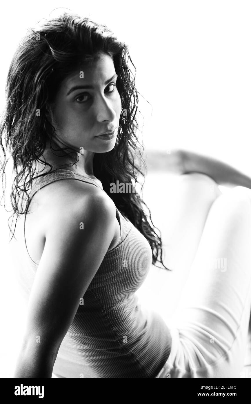 Portrait of a young woman sitting Stock Photo - Alamy