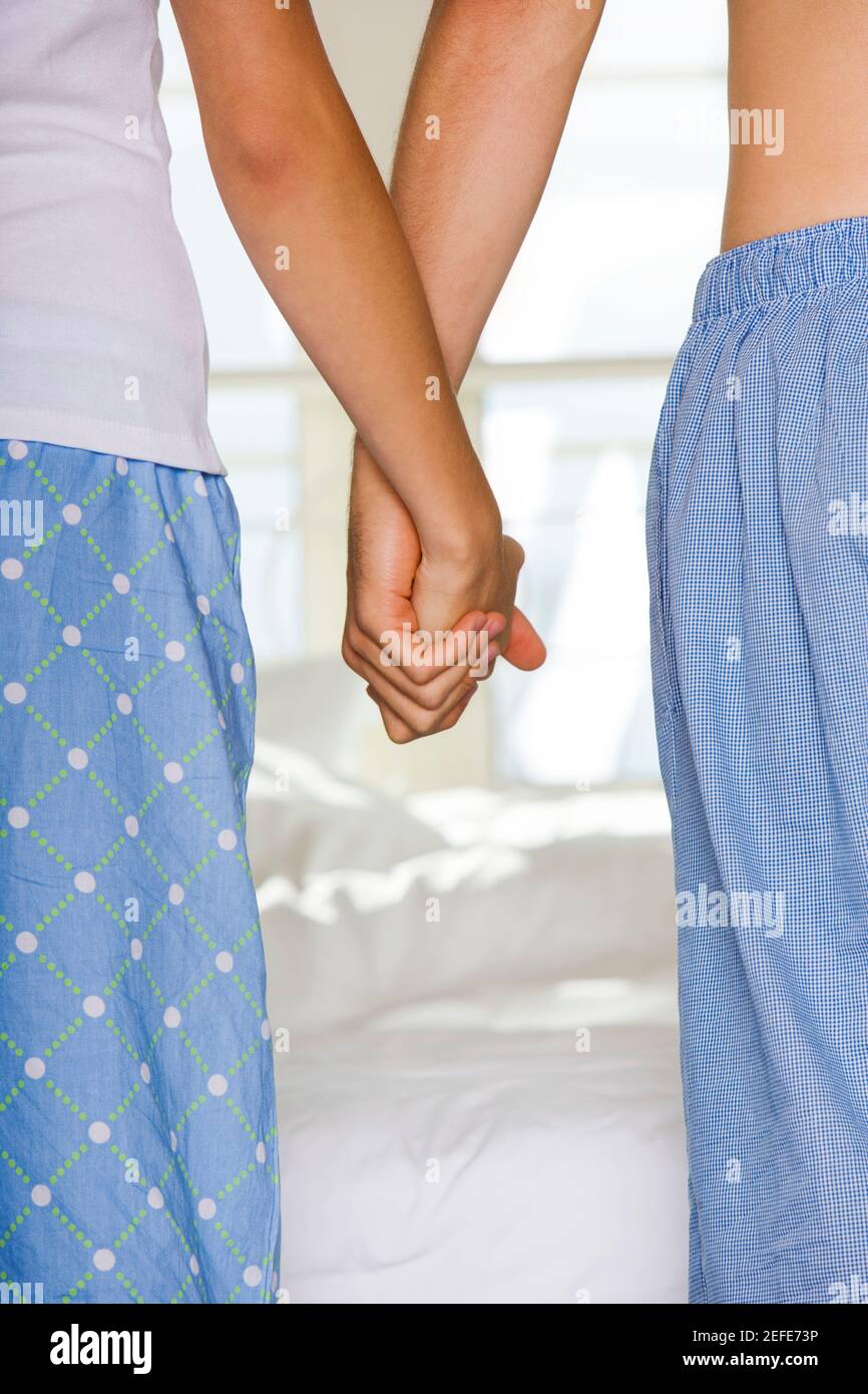 Mid section view of a young couple holding hands Stock Photo