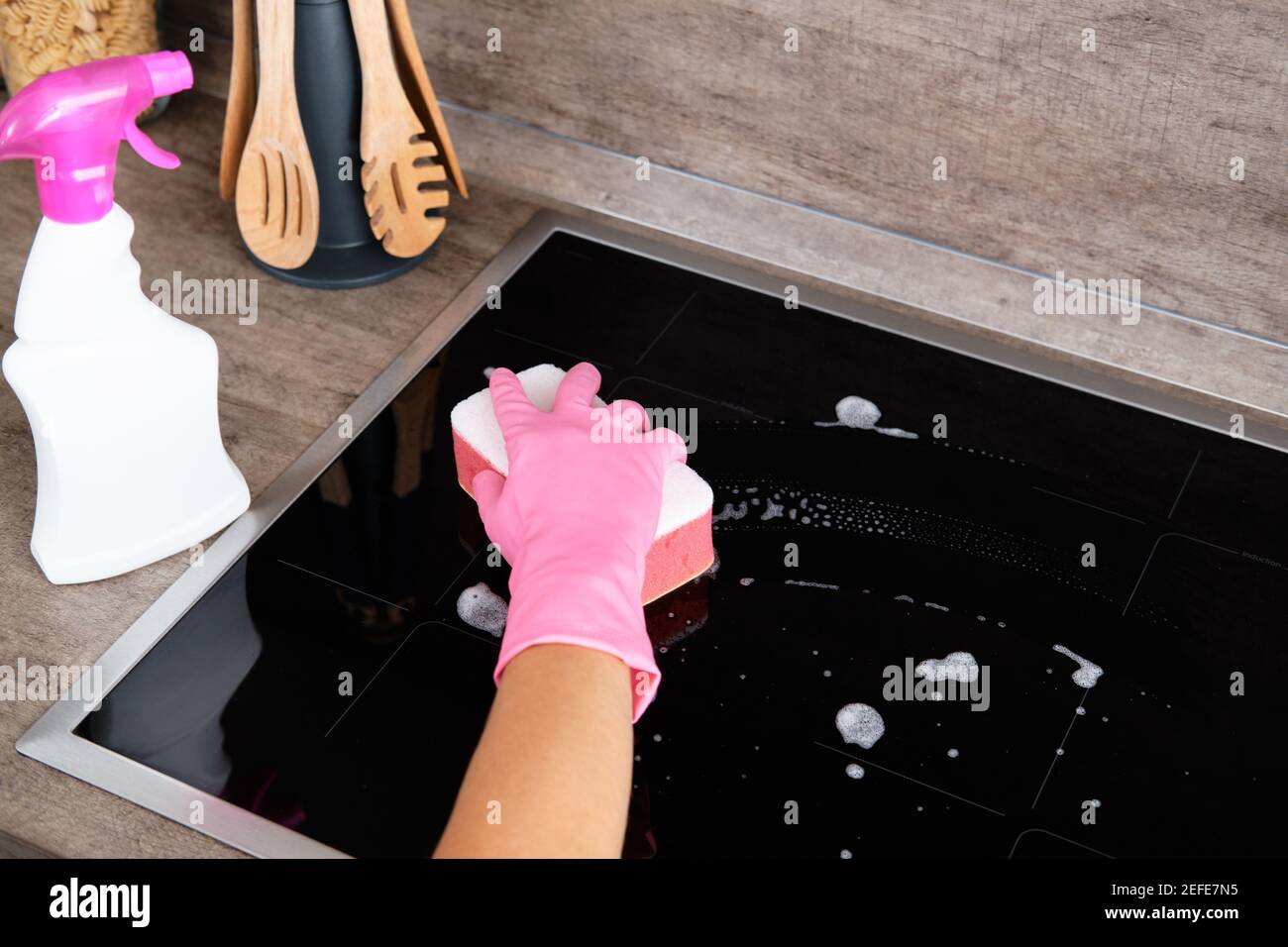 Cleaning Induction Hob. Washing a kitchen. Cleaning service concept Stock Photo Alamy
