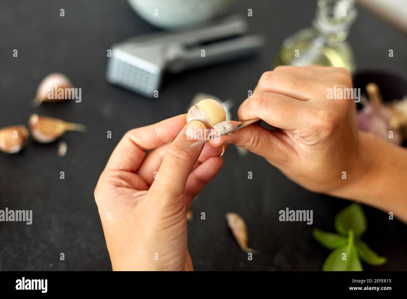 Woman peeling garlic hands knife hi-res stock photography and images ...