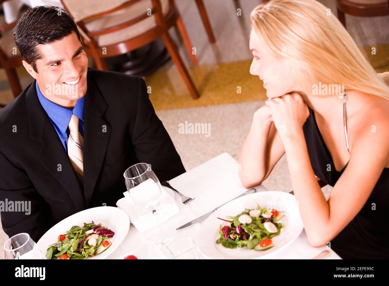 High angle view of a mid adult man and a young woman sitting at a table in a restaurant Stock Photo
