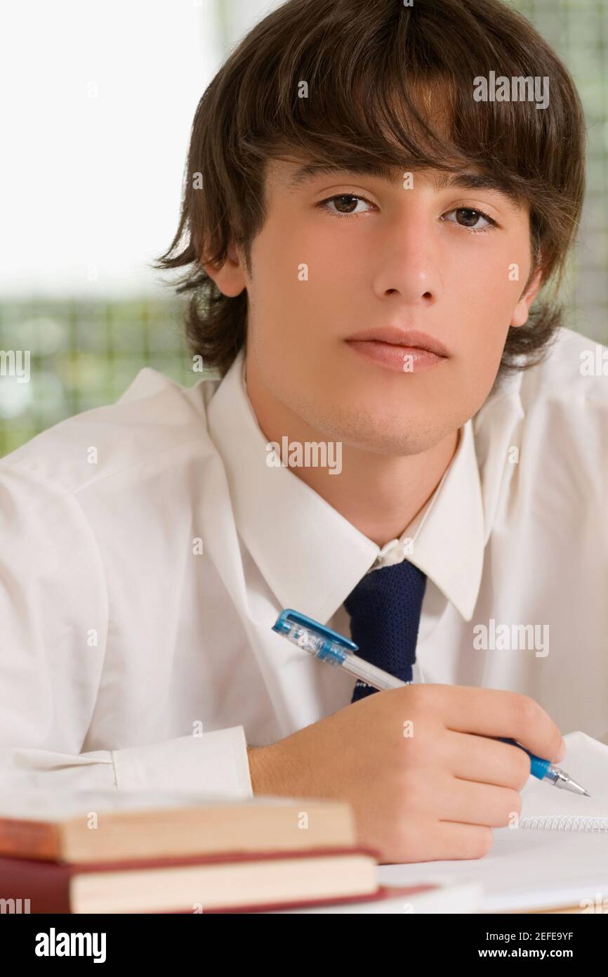 Close up of a high school student writing in a notebook Stock Photo