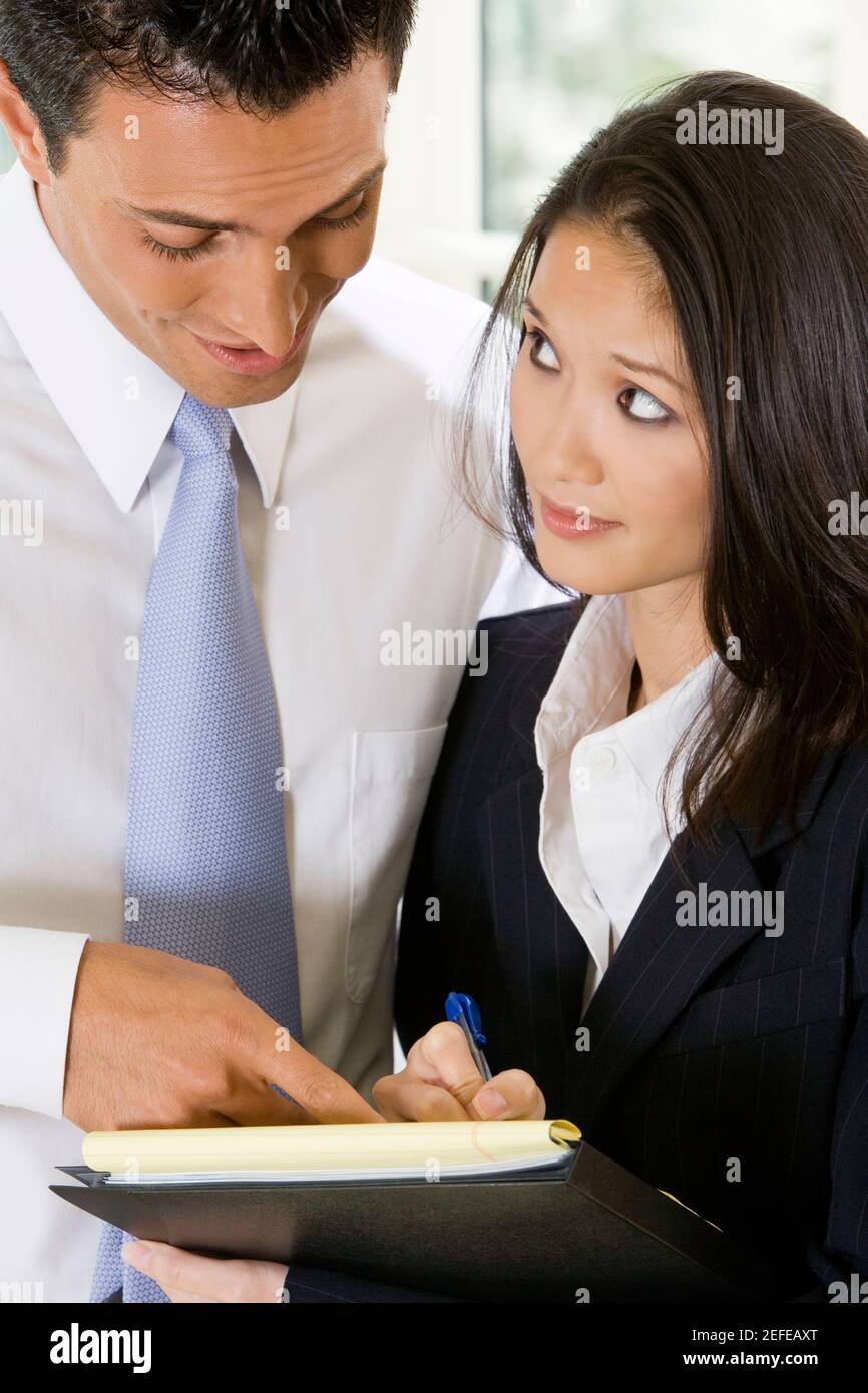 Close-up of a businessman dictating notes to his secretary Stock Photo ...