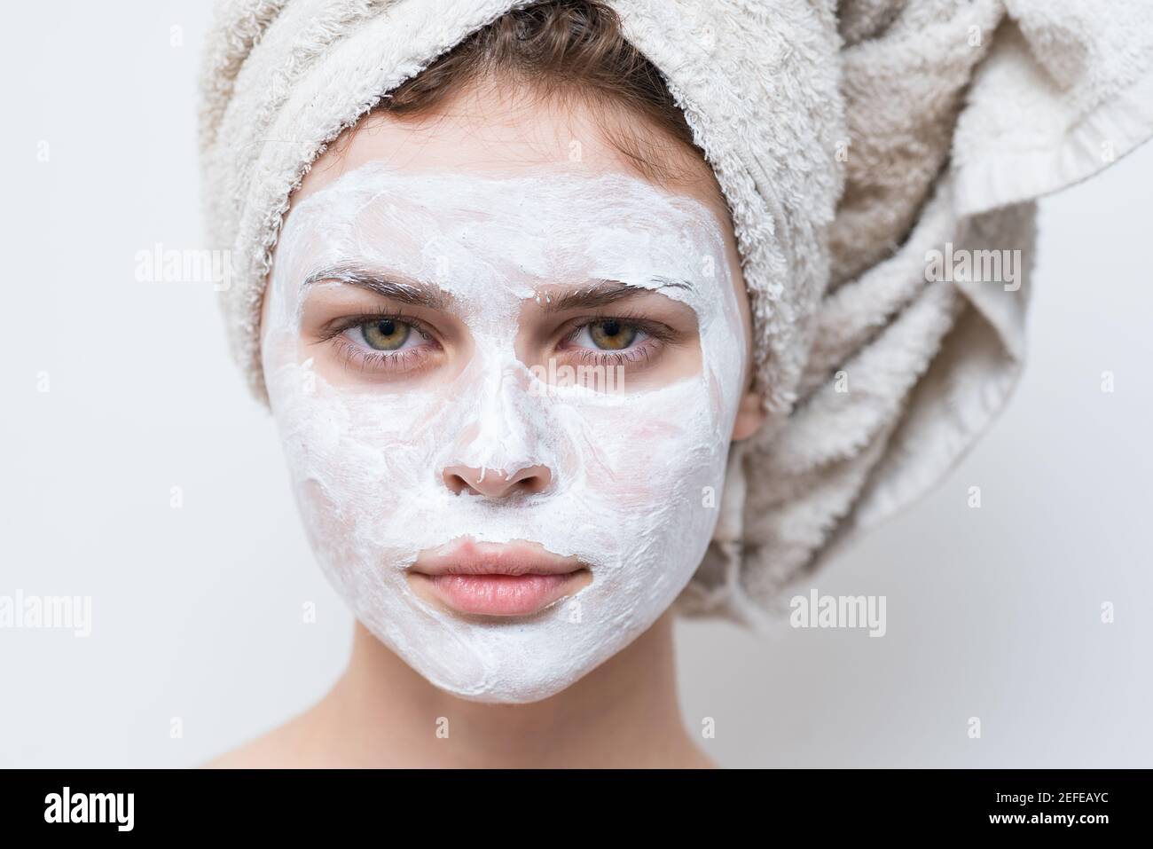 beautiful woman with white mask against black dots on her face Stock