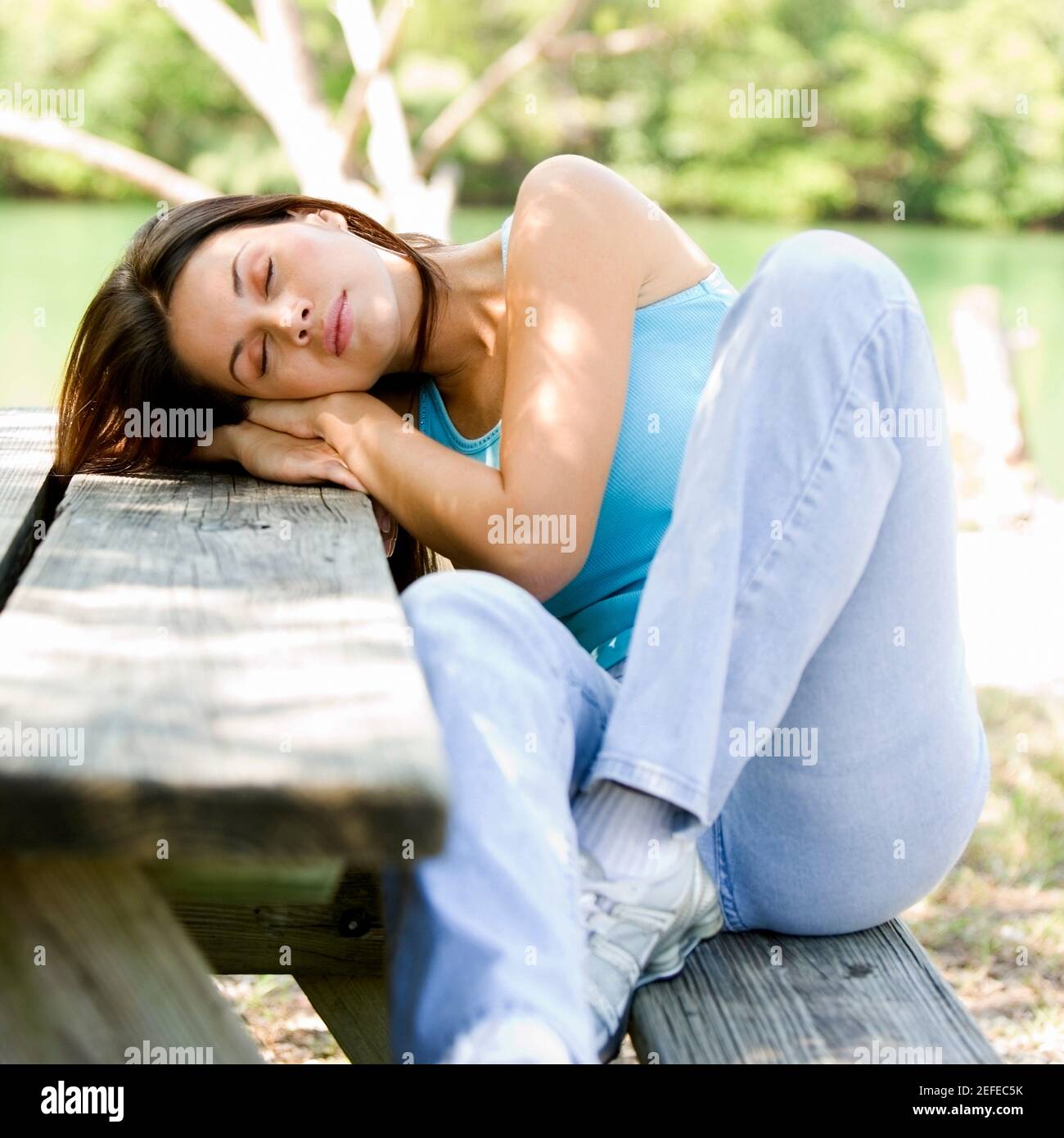 Young woman sleeping on bench hi-res stock photography and images - Alamy