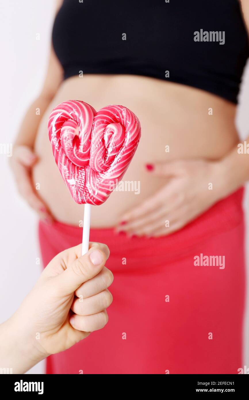 Pregnancy and pink candy, Expecting for sweet baby girl, pregant woman
