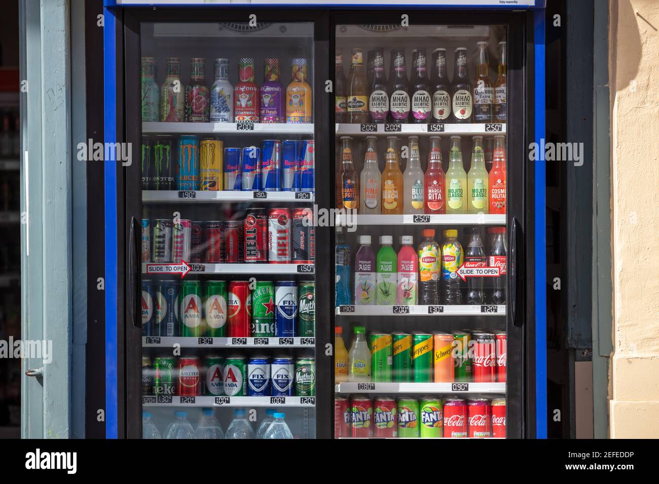 Greece, Athens historic center. February 11, 2021. Refreshments, outdoors refrigerator background. Exterior fridge cabinet with beverage variety for p Stock Photo