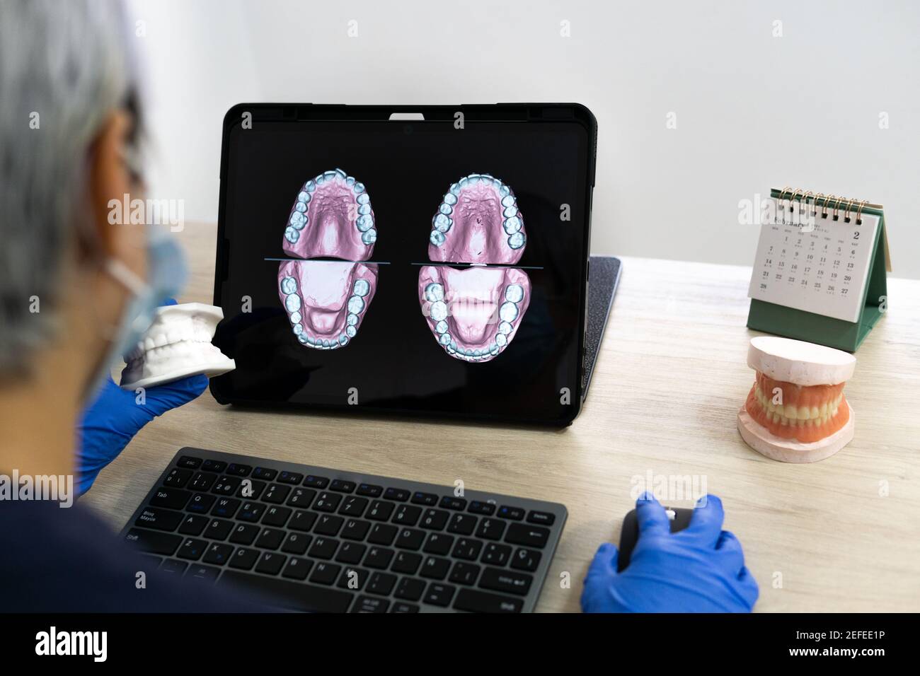 Dental Computer Rpogram Dental technician designing a new dental prosthesis on the computer ...