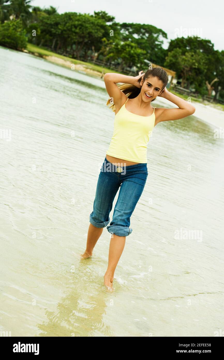 Girl wading in water on the beach Stock Photo Alamy