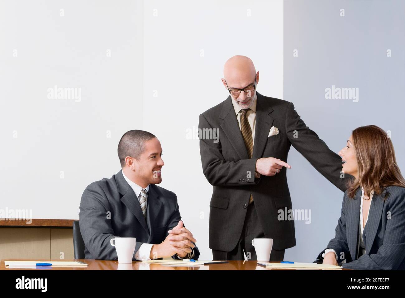 Business executives discussing in a board room Stock Photo