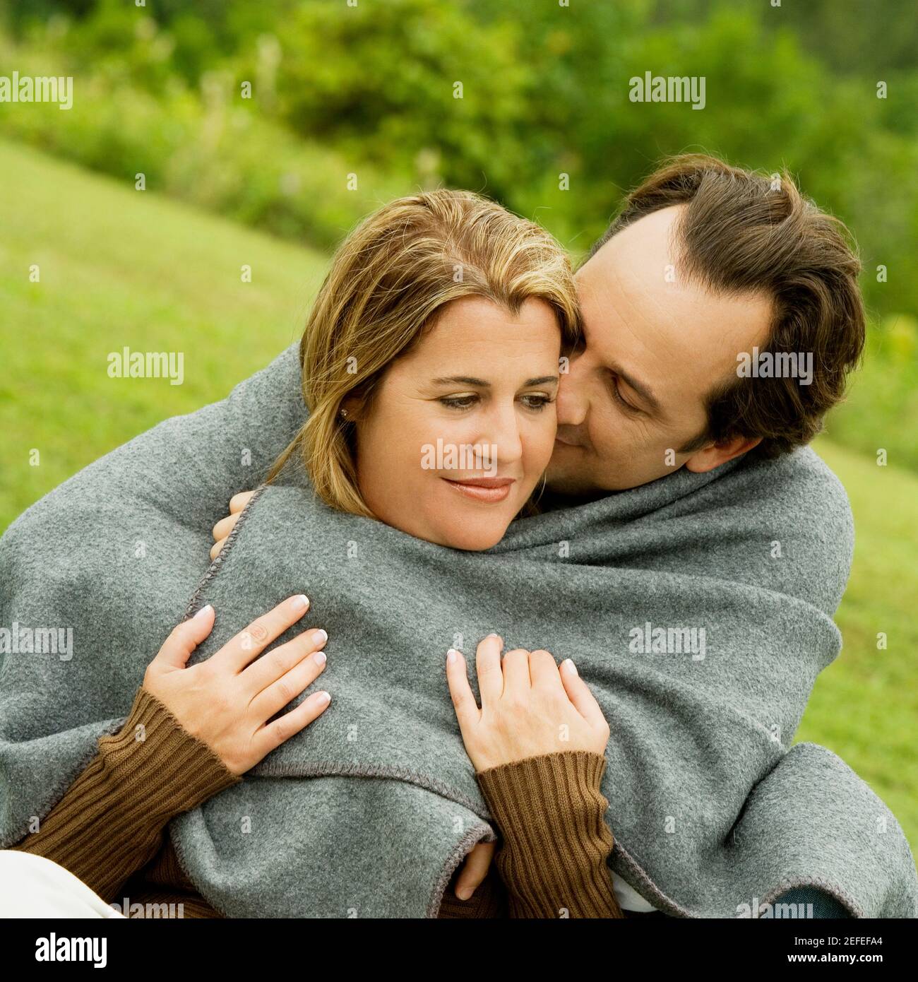 Close-up of a mature man embracing a mid adult woman Stock Photo - Alamy