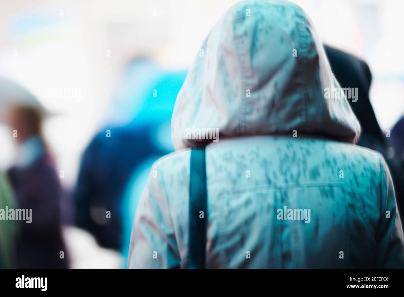Rear view of a person wearing a raincoat Stock Photo