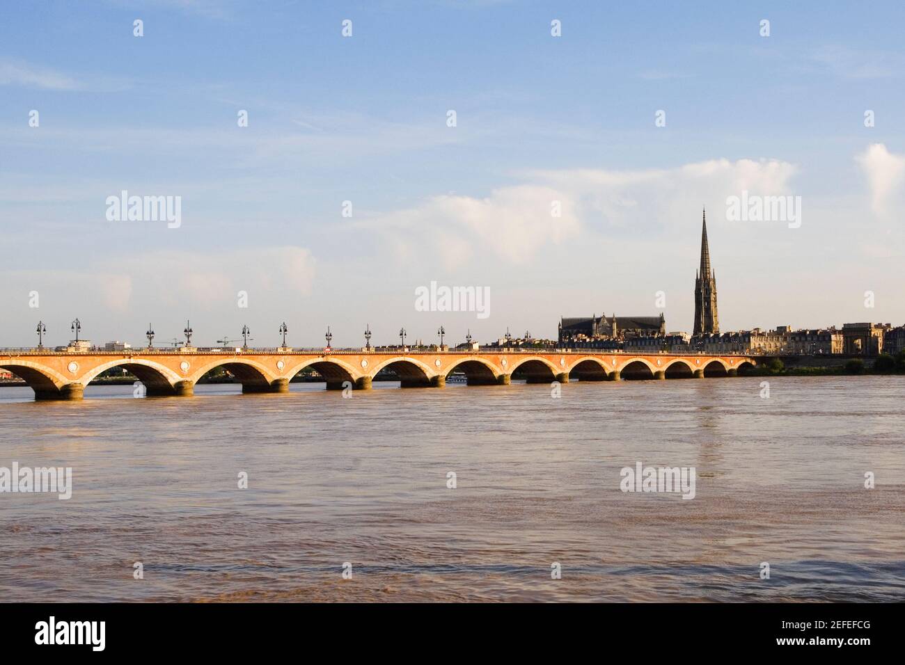Arch bridge across a river, Pont De Pierre, St. Michel Basilica, Garonne River, Bordeaux, Aquitaine, France Stock Photo