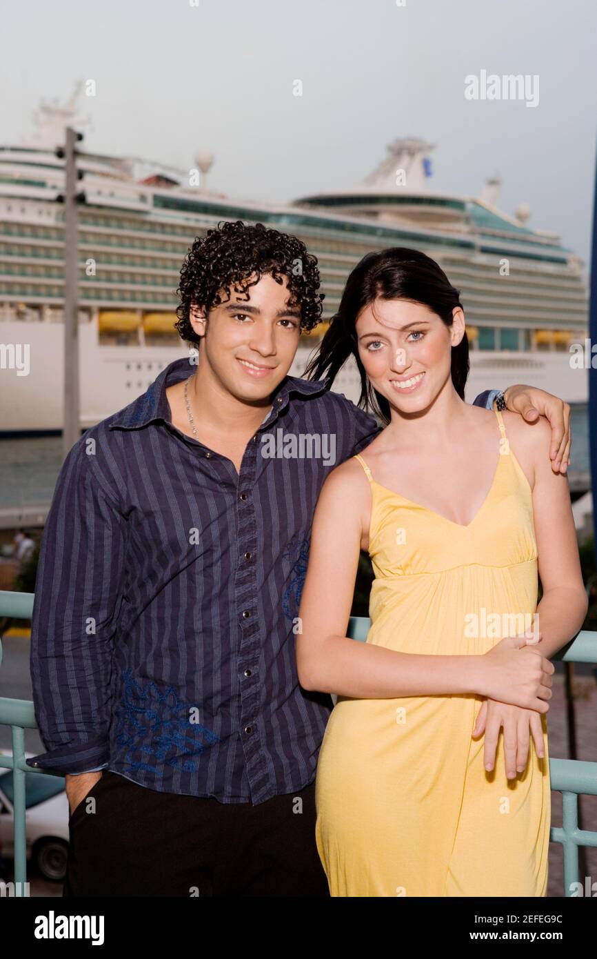 Portrait of a young man and a teenage girl standing together and ...