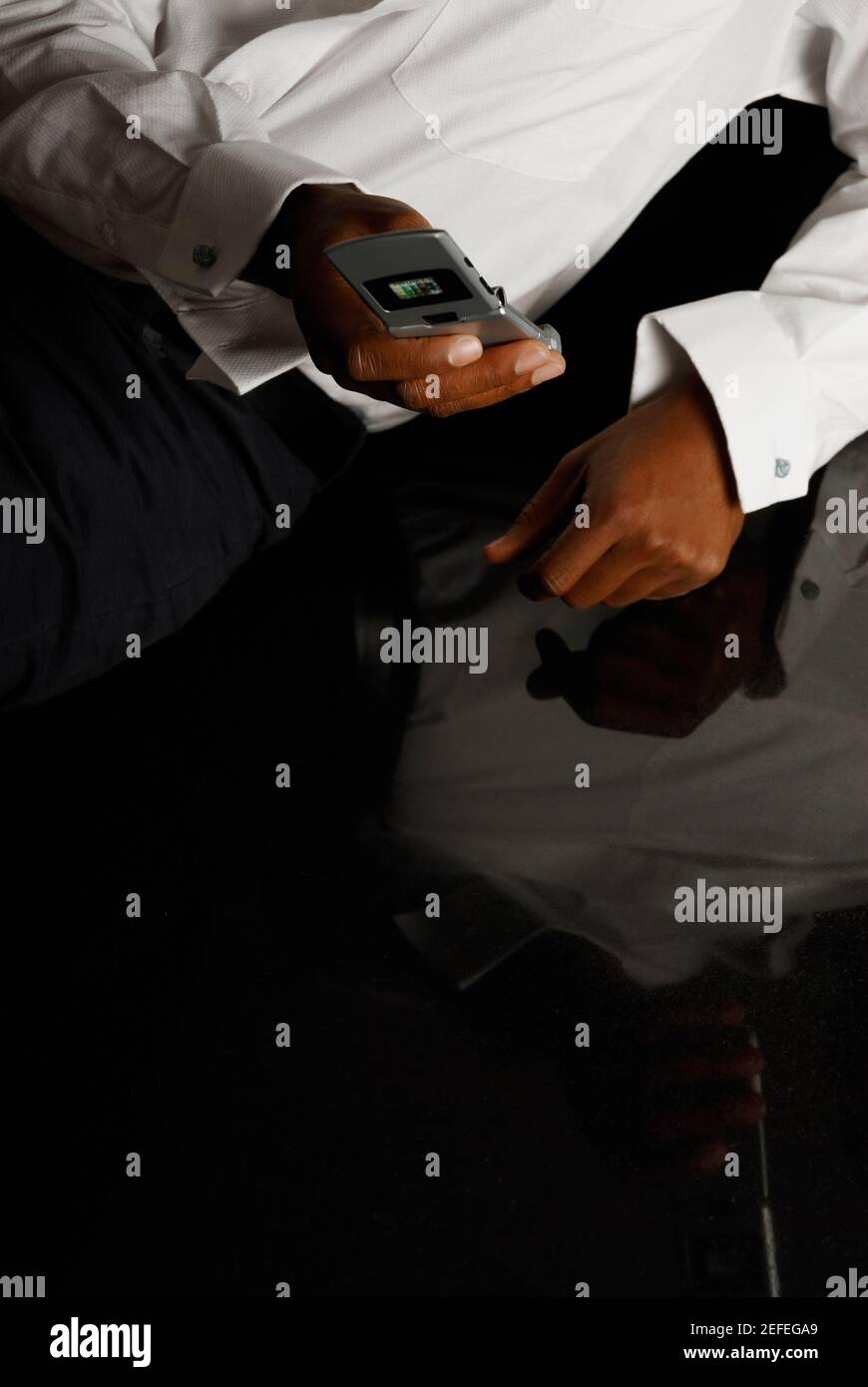 Mid section view of a person using a mobile phone Stock Photo