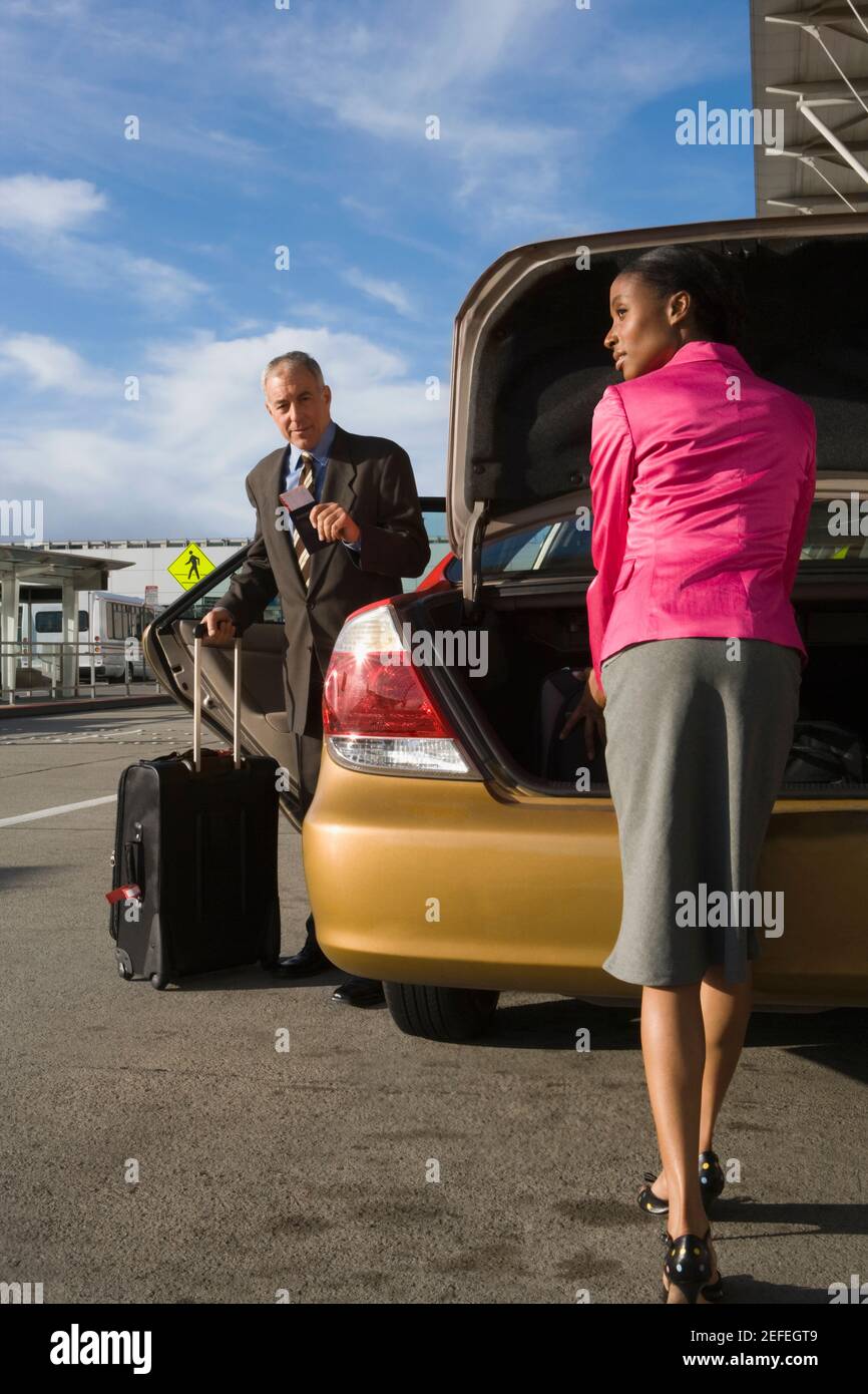 Businessman unloading luggage from car hi-res stock photography and ...