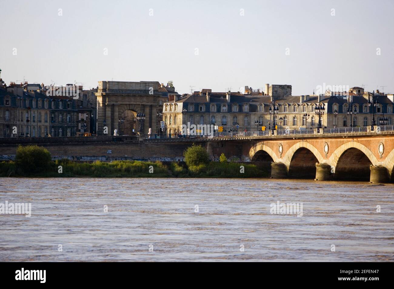 Arch bridge across a river, Pont De Pierre, Porte De Bourgogne, Garonne River, Bordeaux, Aquitaine, France Stock Photo