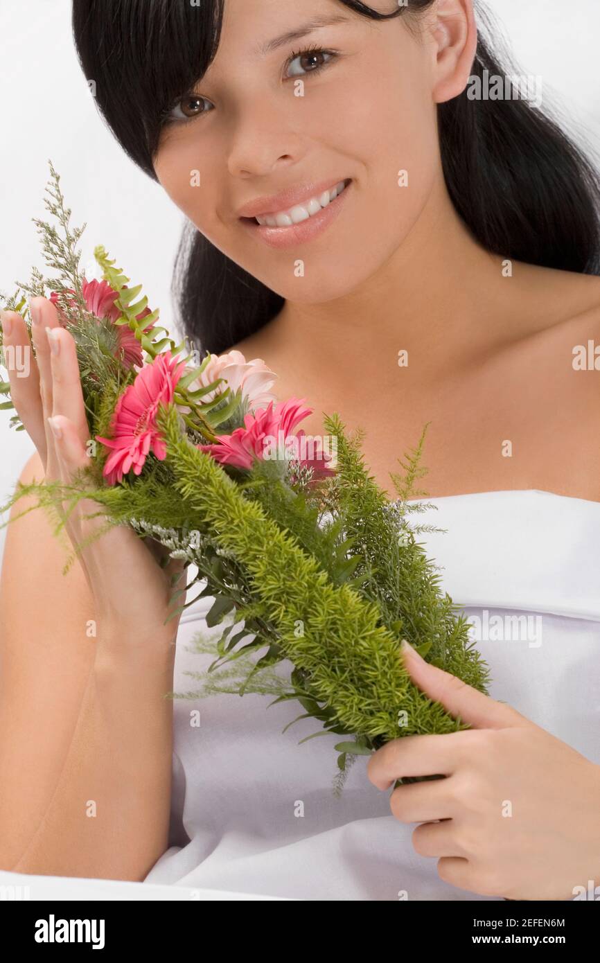 Portrait of a young woman holding a bouquet and smiling Stock Photo - Alamy