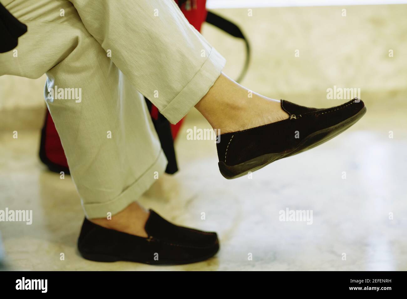 Low section view of a person sitting Stock Photo - Alamy