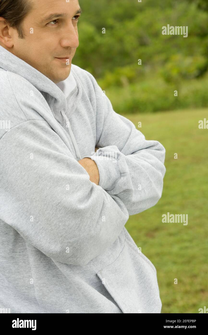 Side profile of a mid adult man with arms crossed Stock Photo - Alamy