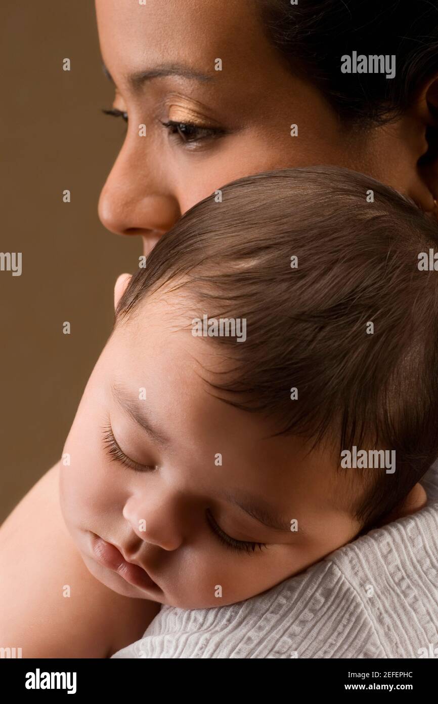 Close up of a young woman carrying her son Stock Photo