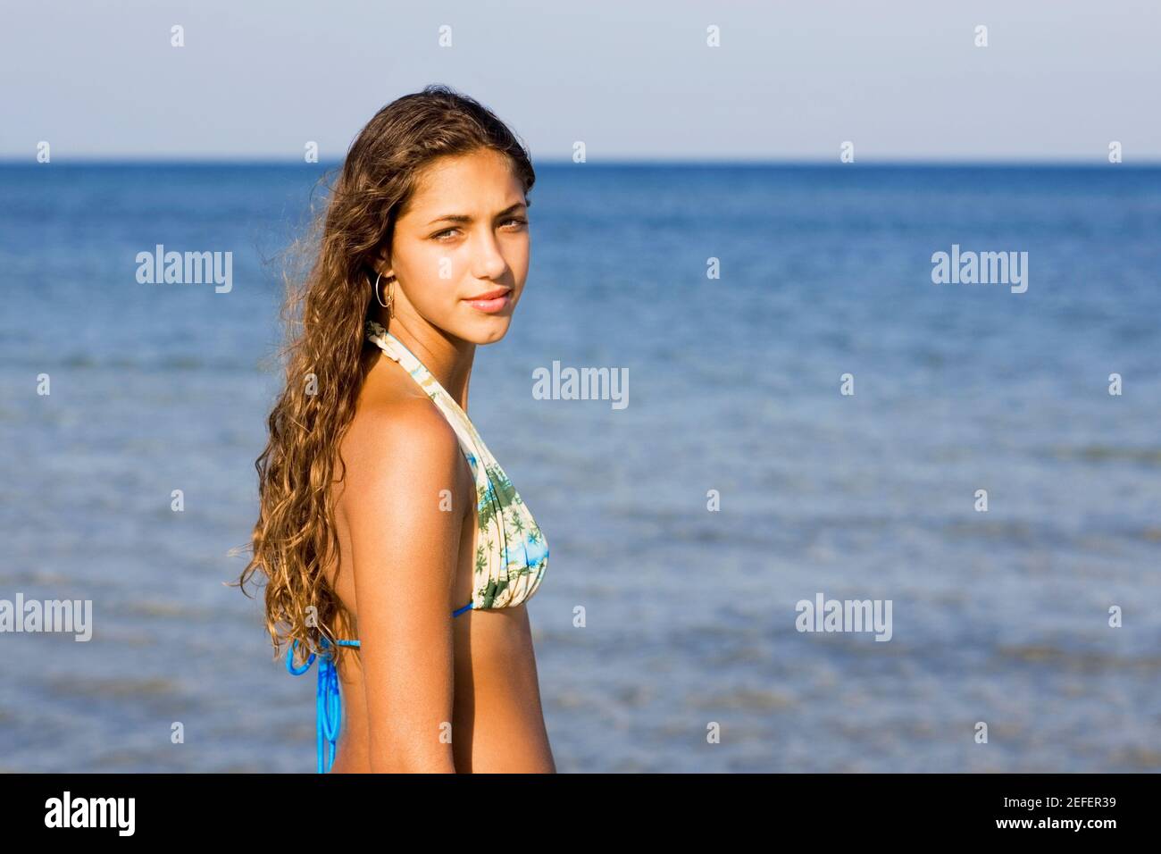 Side profile of a teenage girl standing on the beach Stock Photo - Alamy